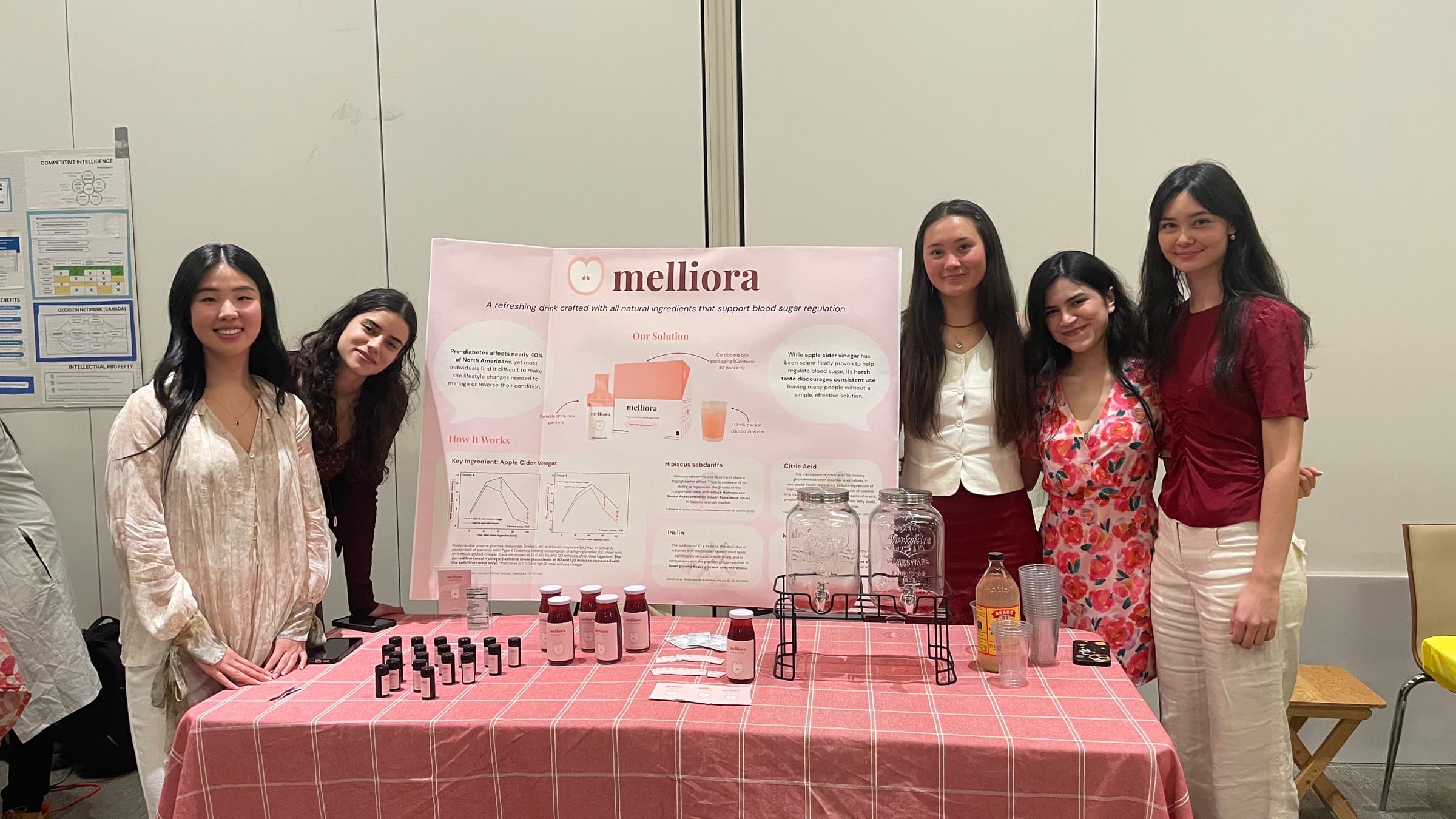 The Melliora team at their demo-day booth